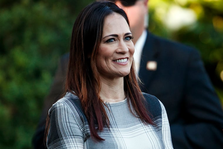 In this June 21, 2019 photo, Stephanie Grisham, spokeswoman for first lady Melania Trump, watches as President Donald Trump and the first lady greet attendees during the annual Congressional Picnic on the South Lawn in Washington. First lady Melania Trump has announced that Grisham will be the new White House press secretary. Grisham, who has been with President Donald Trump since 2015, will also take on the role of White House communications director. (AP Photo/Jacquelyn Martin)