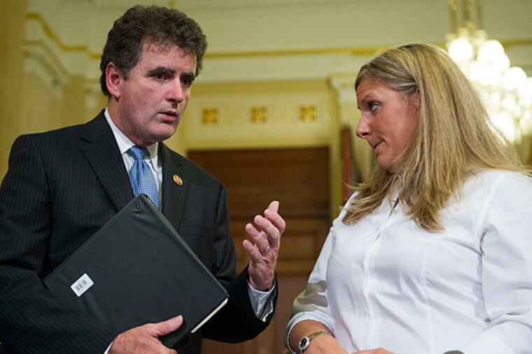 Rep. Mike Fitzpatrick (R., Pa.) talking with Kristen Ruell, a seven-year employee of the VA and one of its most prominent whistle-blowers, before a House Committee on Veterans Affairs hearing in July.