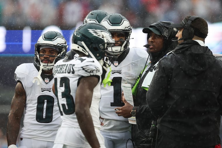 Eagles offensive coordinator Brian Johnson (second right) during a timeout against the New England Patriots at Gillette Stadium in Foxborough, MA on Sunday, Sept. 10, 2023