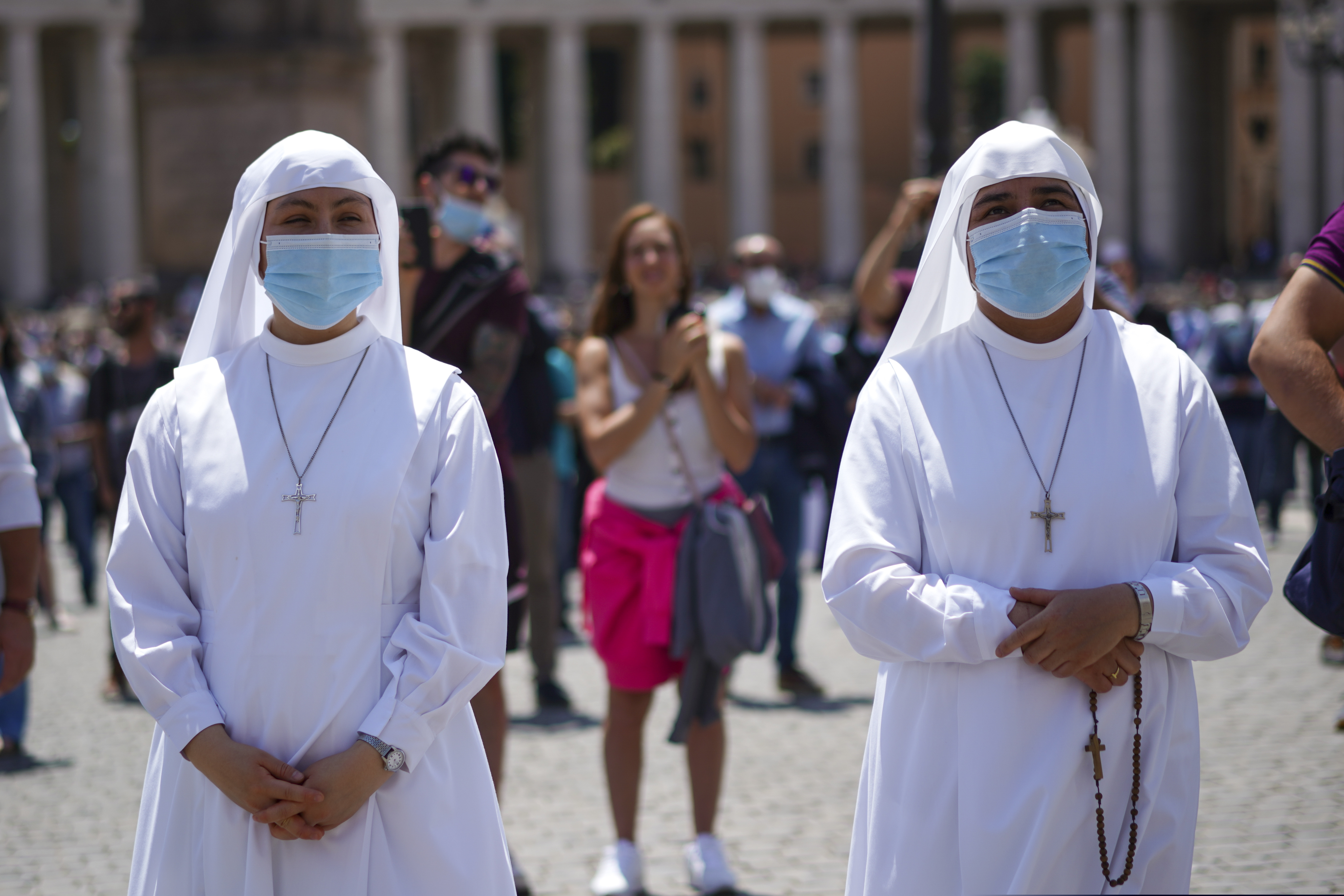 Nuns listen as Pope Francis delivers his blessing as he recites the Angelus noon prayer from the window of his studio overlooking St.Peter's Square, at the Vatican on June 7, 2020. Pope Francis is cautioning people in countries emerging from lockdown to keep following authorities’ rules for COVID-19 contagion containment. Says Francis: “Be careful, don’t cry victory, don’t cry victory too soon.”