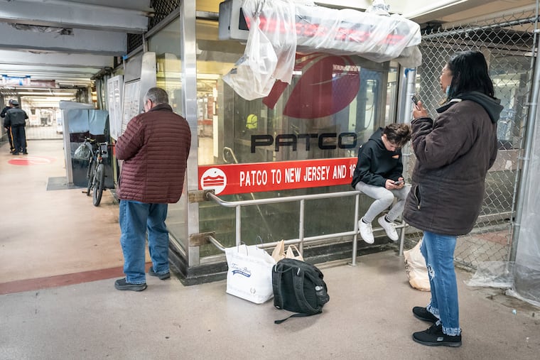 People wait at the 8th and Market PATCO station after service was suspended because of Friday's earthquake.