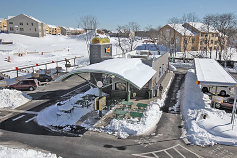 Snow covers the drive-in and parking lot Friday of the SONIC on Bustleton Pike in Feasterville. (David M Warren / Staff Photographer)