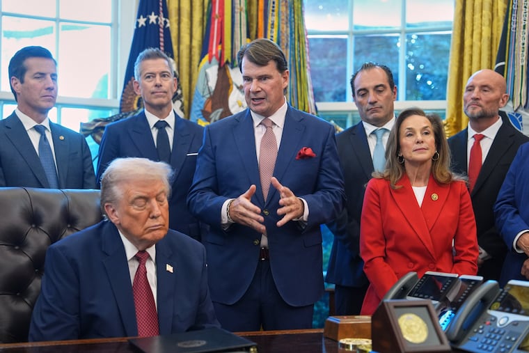 Ford President Jim Farley speaks as President Donald Trump looks on during an event on fuel economy standards in the Oval Office of the White House, Wednesday, Dec. 3, 2025, in Washington.