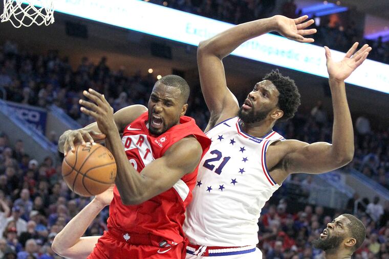 Toronto's Serge Ibaka pulls down a rebound during Game 4 of the Eastern Conference Semifinals on Sunday. The Raptors beat the Sixers, 101-96, to tie the series at two.