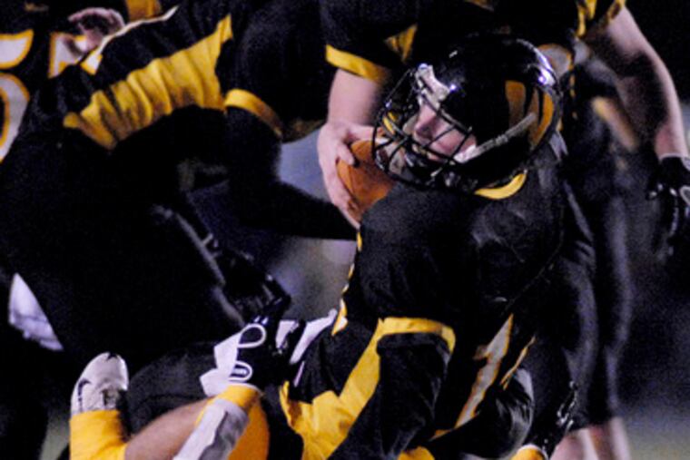 Wood quarterback Sean McCartney is sacked by Jefferson's Dan Virgin, who also had a TD reception on offense.