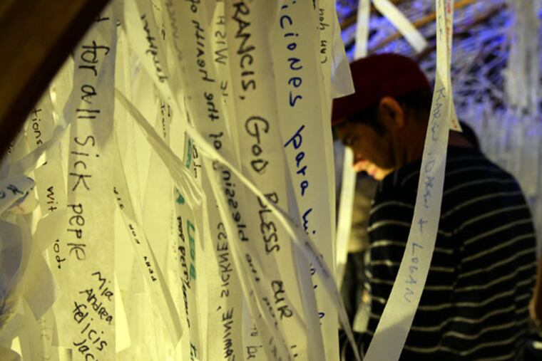 Knotted Grotto visitors write a prayer request on a strip of cloth, then choose and pray for a stranger’s. (TOM GRALISH/STAFF PHOTOGRAPHER)
