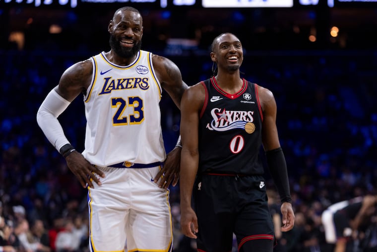 Los Angeles Lakers' LeBron James, left, talks with Philadelphia 76ers' Tyrese Maxey, right, during the first half of an NBA basketball game, Sunday, Dec. 7, 2025, in Philadelphia. (AP Photo/Chris Szagola)