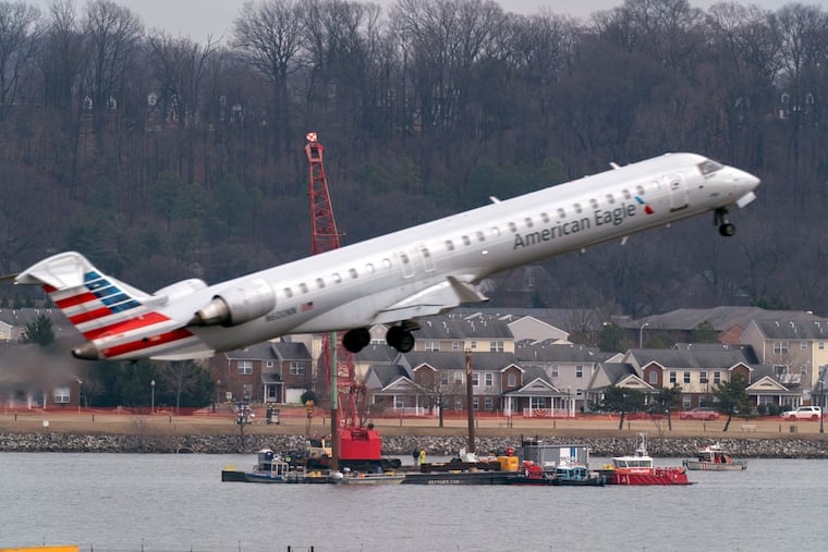 Salvage crews work on recovering wreckage near the site in the Potomac River of a mid-air collision between an American Airlines jet and a Black Hawk helicopter at Ronald Reagan Washington National Airport in Arlington, Va.