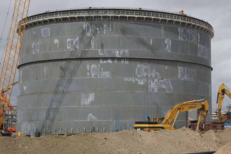 Sunoco is transforming it old petroleum refinery in Marcus Hook to one that handles and stores natural gas liquids produced from the Marcellus Shale. Sunoco Logistics is building new above-ground storage equipment, like this new 300,000 barrel tank for ethane, shown on April 14, 2014. ( CLEM MURRAY / Staff Photographer, file )