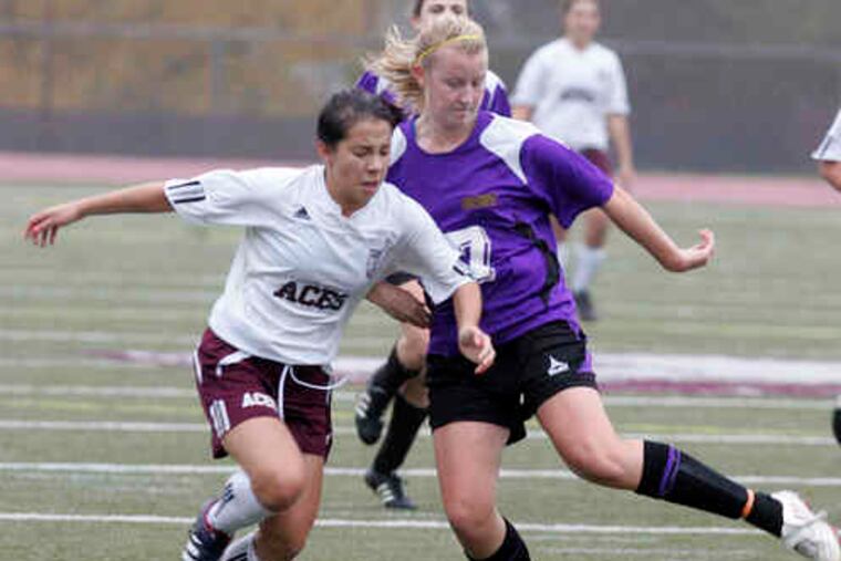 Lower Merion's Patricia Neckowicz (left) races for the ball with Mount St. Joseph's Kelly Moran.Neckowicz scored the second goal for the Aces, who will face Downingtown East tomorrow.