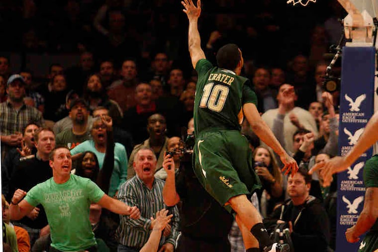 Villanova's Antonio Pena watches from floor as South Florida's Anthony Crater takes shot after stealing inbounds pass.