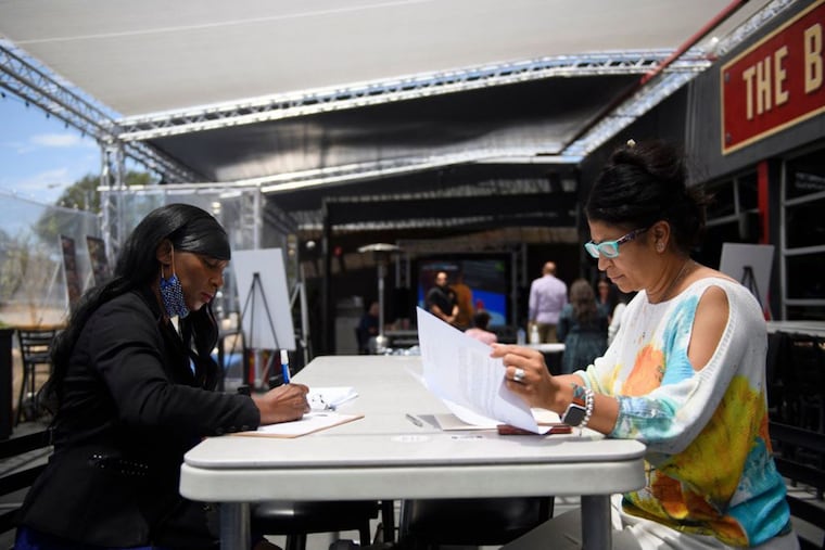 Sandra Presley (left) interviewing for a job as a hotel front desk staff member with a human resources manager during a job fair in June in Torrance, Calif.