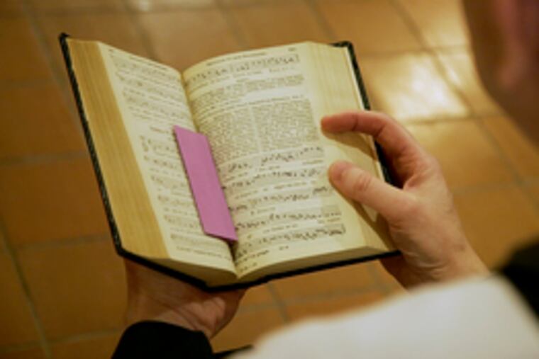 A Latin prayer book is used at Mass at Mater Ecclesiae Church in Berlin Twp. Members are excited by the pope's decree backing freer use of the Latin liturgy.