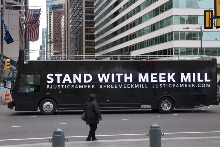 Buses with signs showing support for Meek Mill circled City Hall on Nov. 14.