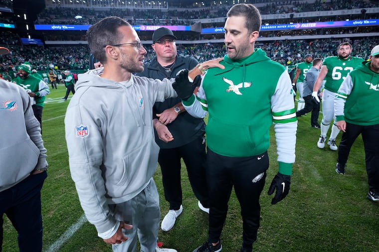 Former Dolphins head coach Mike McDaniel (left) shown with Eagles coach Nick Sirianni after their matchup in 2023.