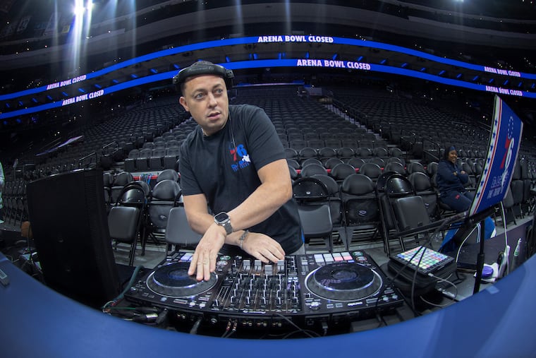 Josh Barrett, also known as DJ Ghost, plays music during a recent Sixers shootaround at the Wells Fargo Center.