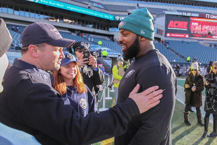 During warmups Saturday, Eagles defensive lineman Fletcher Cox, right, visited with Luke LeTourneau, left, and Michelle Ciano, center, brother and sister of Philadelphia firefighter Lt. Matt LeTourneau, who lost his life last Saturday battling a rowhouse fire in North Philadelphia. MICHAEL BRYANT/ Staff Photographer