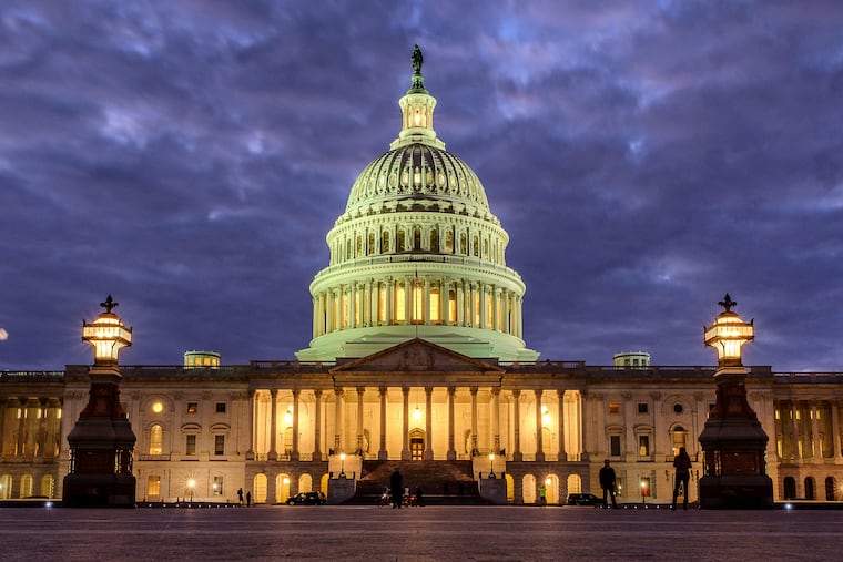 FILE - Lights shine inside the U.S. Capitol Building as night falls on Jan. 21, 2018, in Washington.