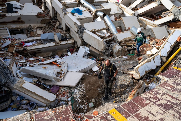 Volunteers and rescuers help to find survivors in a collapsed building in Caraballeda, La Guaira, Venezuela Tuesday, June 30, 2026, following two powerful earthquakes.