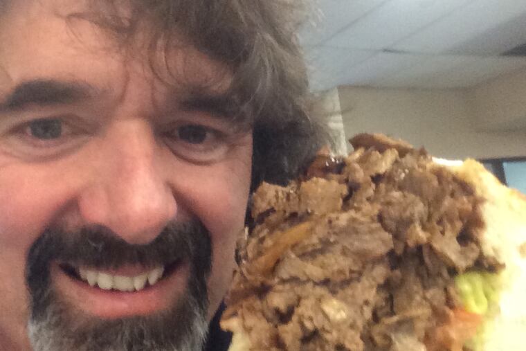 Jim Pappas posing with his 200th cheesesteak at John's Pizza in Malvern, Pa.