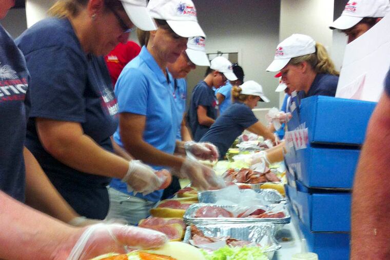 About 150 Wawa associates prepared 17,000 hoagies yesterday for the Wawa’s 22nd Hoagie Day held at Independence Mall. Patricia Madej
