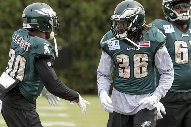 Newly acquired Eagles running back Jay Ajayi (right) looks to Corey Clement during his first practice with the Eagles at the NovaCare Complex on Wednesday.