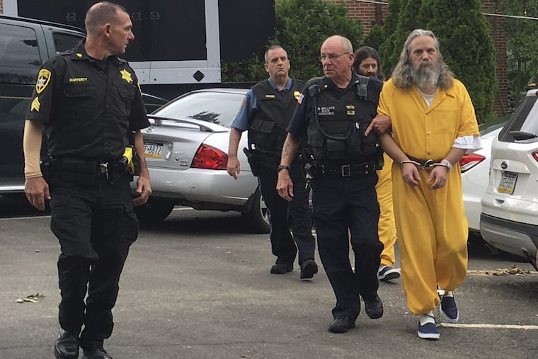 Lee Kaplan is led to a hearing in August 2016. He is being sentenced Wednesday on 17 counts of child sexual assault.