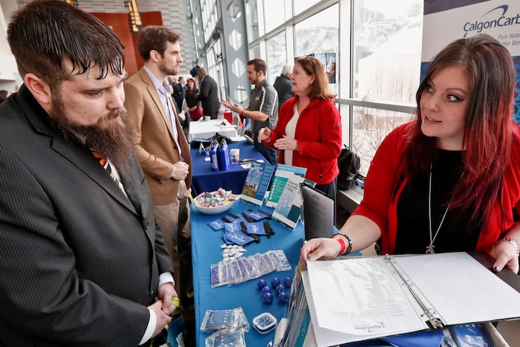 In this March 7, 2019, file photo visitors to the Pittsburgh veterans job fair meet with recruiters at Heinz Field in Pittsburgh. (AP Photo/Keith Srakocic, File)