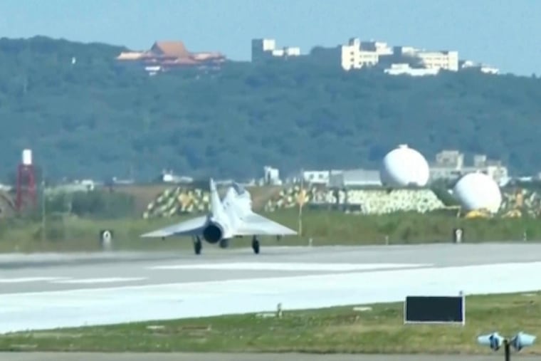 In this image taken form video, a Taiwan fighter jet lands at the Hsinchu Airbase in Taiwan on Monday, Dec. 29, 2025.