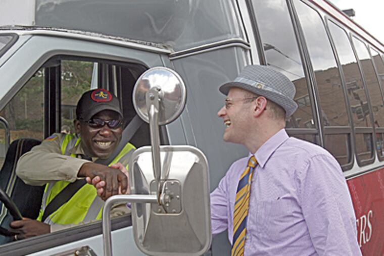 On campus, Andrew Seligsohn (right), civic engagement chief, with Elijah Sykes of security staff. (Akira Suwa / Staff Photographer)