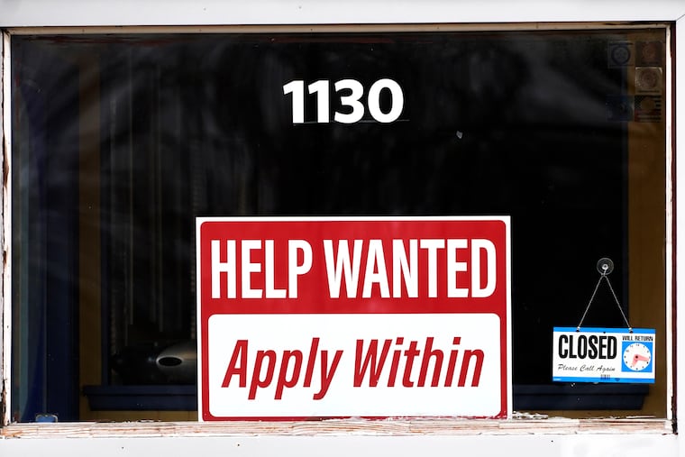 A "help wanted" sign is seen at an Allstate insurance office in Elgin, Ill., March 19, 2022.