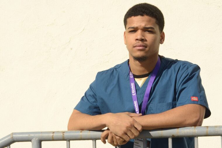 Isaiah Gonzalez, a patient services representative in the Einstein Healthcare Network. He is shown here outside his office in Mayfair.
