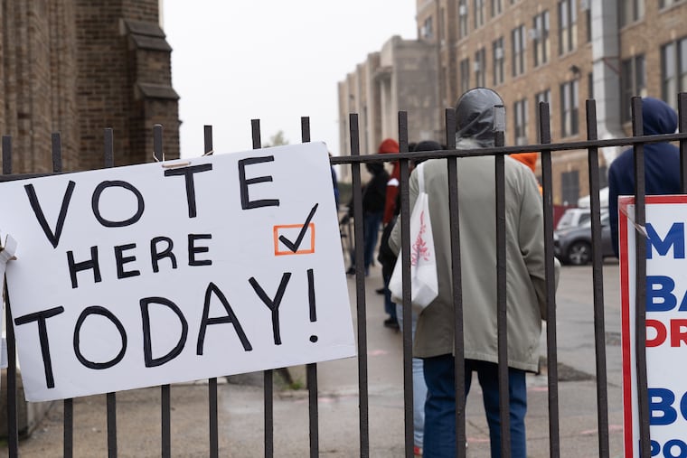 People wait to vote at Tilden Middle School at 66th and Elmwood Avenue in Philadelphia on Oct. 26, 2020.