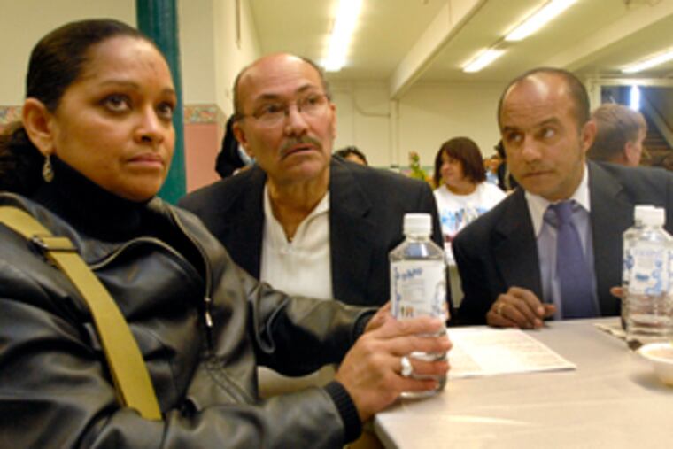 Among those attending the prayer breakfast at Our Lady of Hope Church are (from left) Evelyn Gutierrez, Carmelo Santiago and Melvin Figueroa, all of whom lost loved ones to homicide. Gutierrez said she prayed for peace and for her father, who was killed this year.
