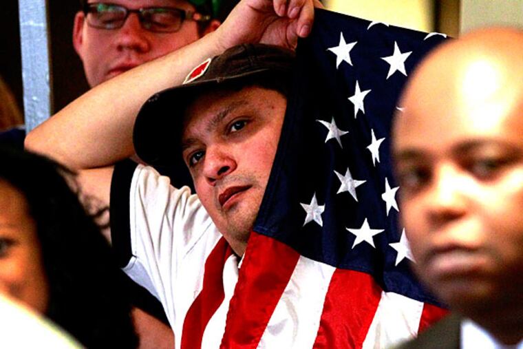 A reader asks columnist Harry Gross: where is the conscience of America when it comes to the poor and unemployed? Here, Democratic supporter Sergio Villarreal holds an American flag during an event supporting President Barack Obama's health care overhaul on Thursday, June 28, 2012 in Fort Worth, Texas. (AP Photo/The Fort Worth Star-Telegram, Ron Jenkins/File )
