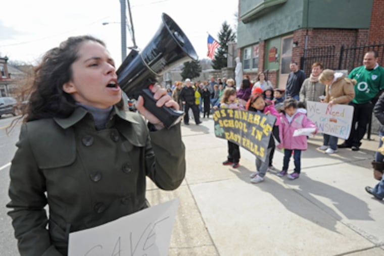 Outside St. Bridget's Catholic Church, Christina Spino leads demonstrators as they rally to save the elementary school on March 4. (April Saul / Staff Photographer)