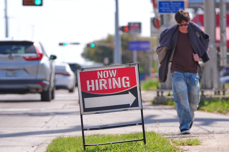 A now hiring sign sits on the side of the road in Garland, Texas, Monday, March 23, 2026.