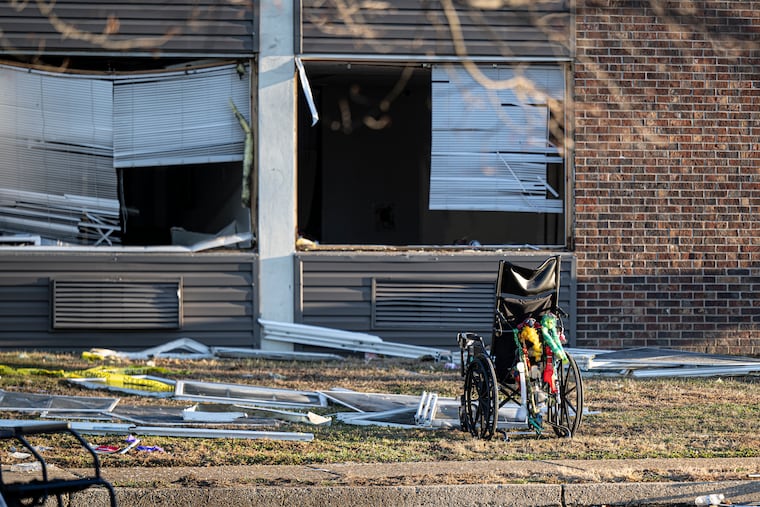 A wheelchair and other debris are scattered amid structural damage after a massive explosion and fire at a nursing home in Bristol on Dec. 24. Two people were killed, and several others were injured.