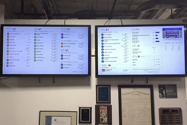 Two screens at Reading Terminal Market display information on transit alternatives for customers.