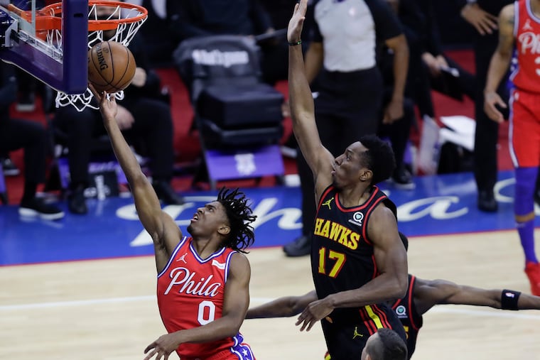 Sixers guard Tyrese Maxey scores past Hawks forward Onyeka Okongwu in the first quarter Sunday.