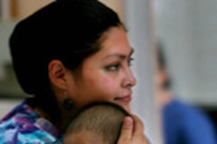 A nurse holds a child at Casa Quivira. Authorities say the home's paperwork fell short, but one activist in the United States praised its facilities.
