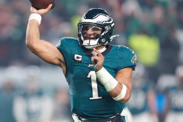 Jalen Hurts and the Eagles moved into first place in the NFC East and clinched a playoff spot Sunday, despite not taking the field until Monday night.