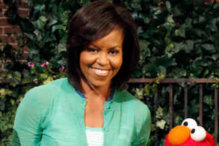 Michelle Obama joins Elmo on "Sesame Street." She planted seeds as part of the show's "My World Is Green & Growing" initiative, designed to foster positive attitudes toward nature.