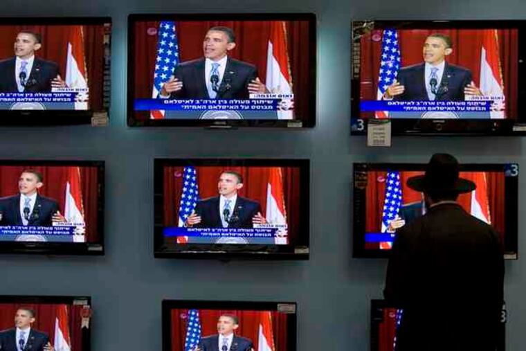 LEFT, TOP: An Orthodox Jew watches Obama's speech on TV screens in Jerusalem yesterday. LEFT, BOTTOM: Pakistanis listen to the speech, translated into Urdu, in Lahore.