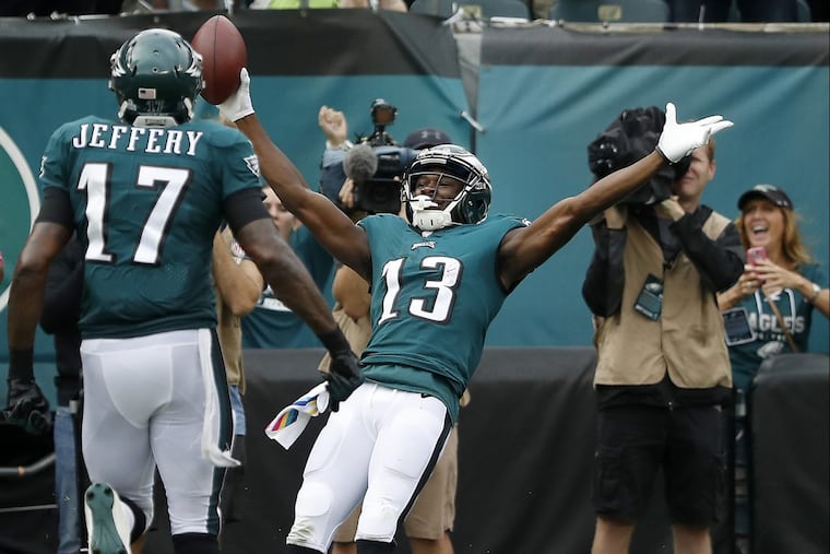 Eagles’ Nelson Agholor, right, falls into the end zone for a fourth quarter touchdown against the Cardinals.