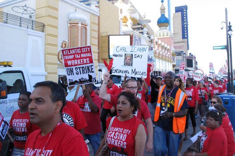 In this July 21, 2016, photo, union members picket outside the Trump Taj Mahal casino in Atlantic City.