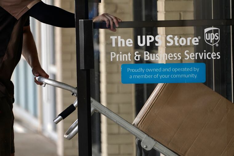 A UPS driver enters a United Parcel Service store in Jackson, Miss., in 2021.