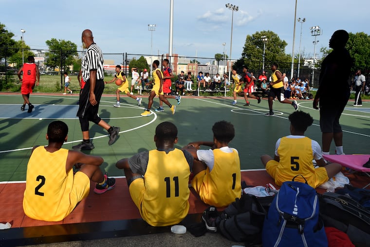 Players watch the action at the Chew Playground courts last month.