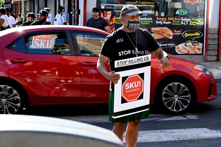 Gun violence prevention advocate Jamal Johnson stages a demonstration June 6, 2022, in the intersection of 3rd and South Streets. He was calling attention to the hundreds of other shootings that have plagued the city this year and asking city leaders to take action, near the scene of Saturday’s mass shooting,