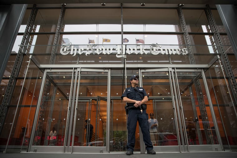 A police officer stands guard outside The New York Times building in 2018.